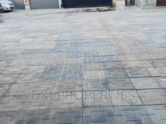 Interior view of a neat and spacious Chamber and Hall (1-bedroom self-contained) apartment in Malejor, showing the tiled floor and fitted kitchen cabinets.
