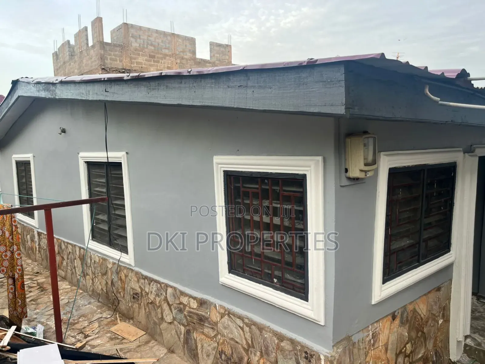 Oyibi 1 (1) Exterior view of a neat, elegant, fenced and gated apartment complex in Oyibi, showing the balcony and proximity to the main road.