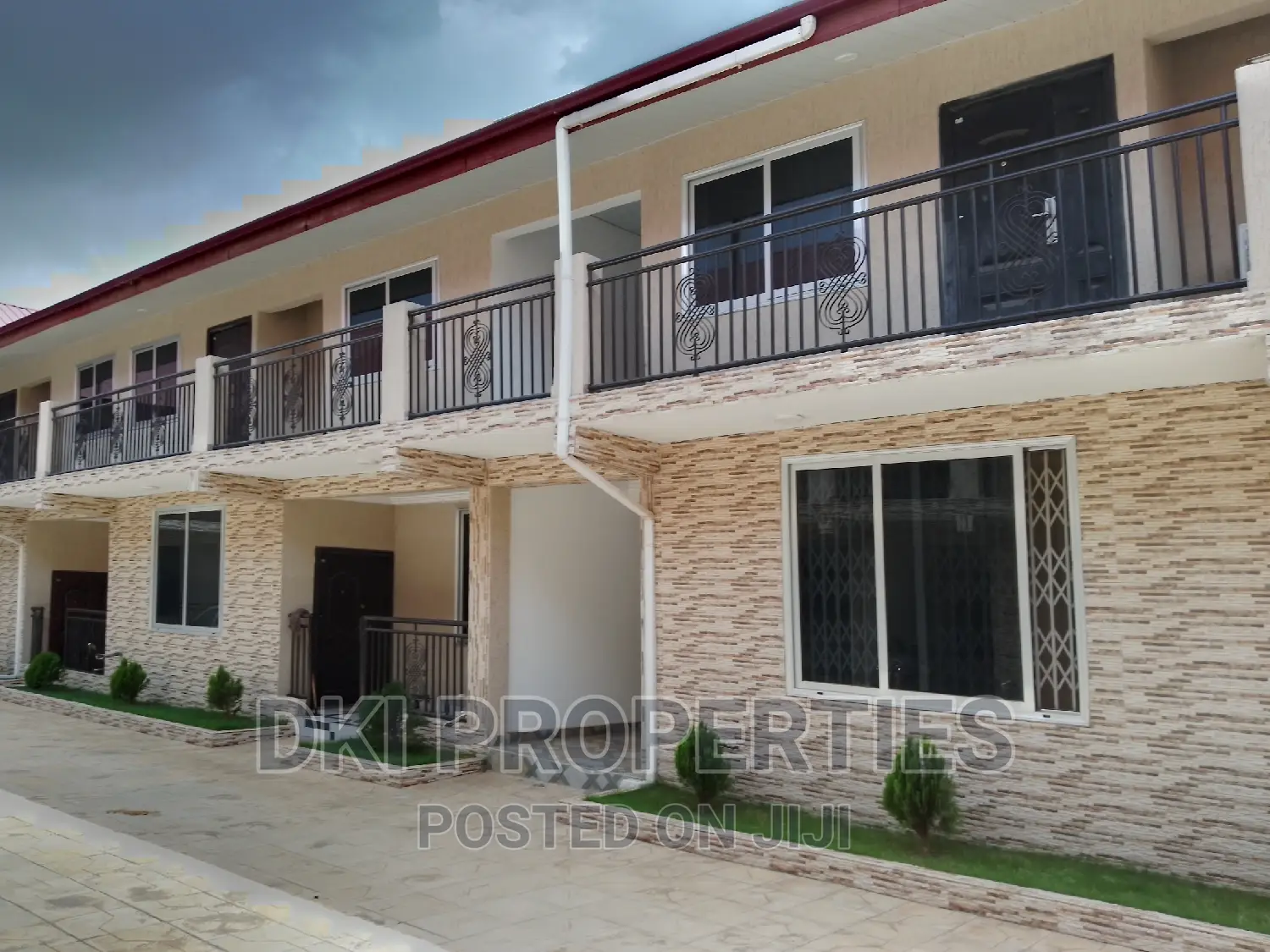 Oyibi 2 (1) Exterior view of a newly-built, neat 2-bedroom apartment complex in Amrahia, showing the modern façade and spacious compound/parking area.