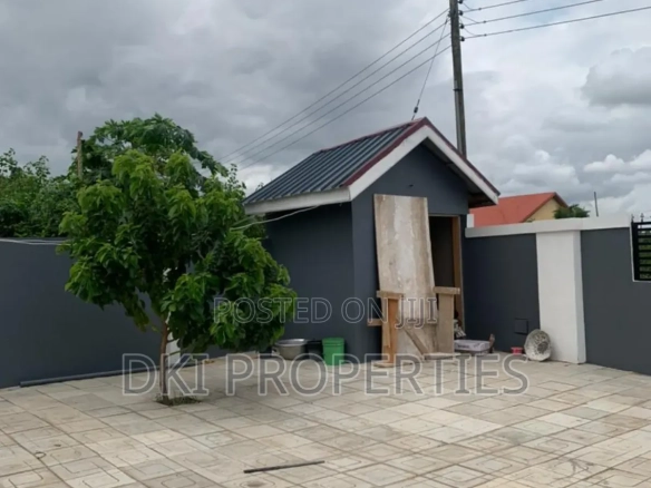 Exterior view of a neat, newly-built 2-bedroom apartment complex in Kpong Bawaleshie on the Adenta-Dodowa road, highlighting the peaceful, serene environment.