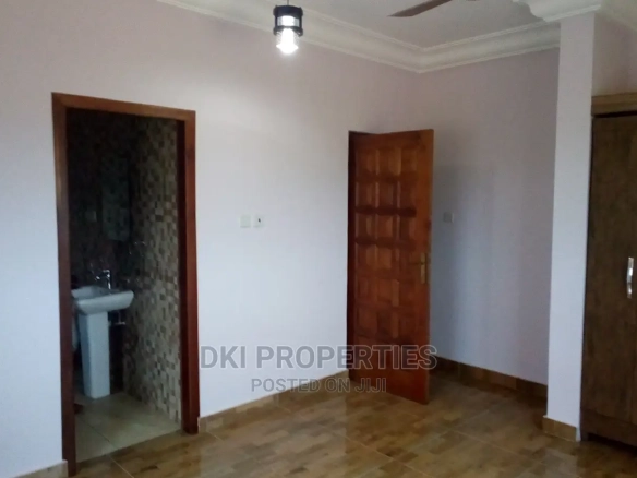 Exterior view of a newly-built executive 2-bedroom apartment complex in Oyibi, showing the clean, modern façade and proximity to the Valley View University campus.