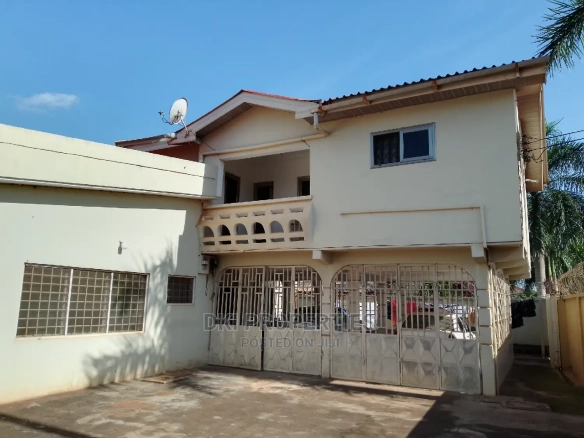 Exterior view of a fairly used, semi-furnished 5-bedroom executive self-compound house on a very large, two-plot titled land in Adenta.