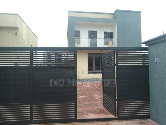 Exterior view of a newly-built, elegant 4-bedroom detached house in East Legon Hills, showing the spacious concrete stamp compound and modern architecture.