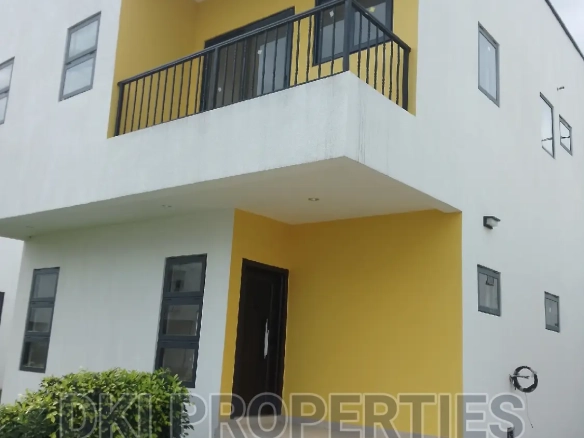 Exterior view of a newly-built, semi-furnished 3-bedroom townhouse with an outer room in a modern and secured gated community in Oyibi.