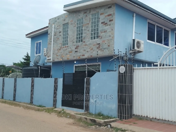 Exterior view of a newly-built, semi-furnished 5-bedroom executive detached house in Tema Community 16, showing the secure wall, compound, and modern architecture.