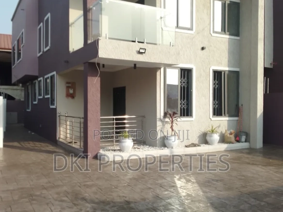 Exterior view of an elegant, newly-built, semi-furnished 4-bedroom detached house in Ampomah, Adenta, showcasing the modern architecture and spacious compound for car parking.