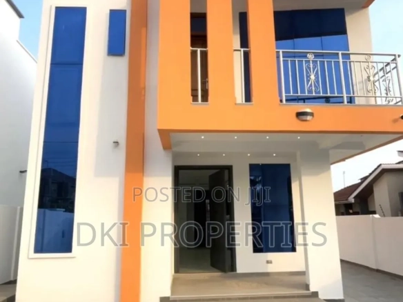 Exterior view of an exquisite, newly-built 3-bedroom detached self-compound house in East Legon near Ogbojo, showcasing modern architecture and a spacious paved compound.